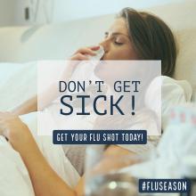 Don't get sick. Get the flu shot. A woman blows her nose. 