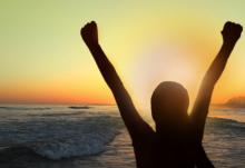 woman raising her hands into the air